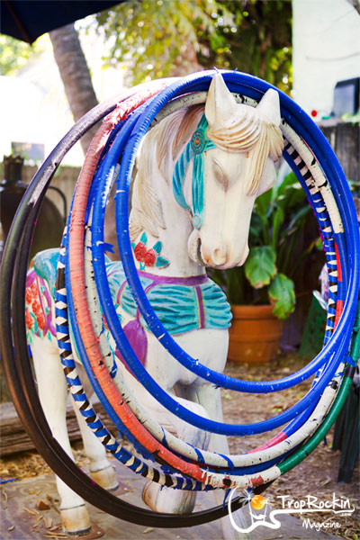 Funky Key West decorations of a horse statue with hula hoops around neck,