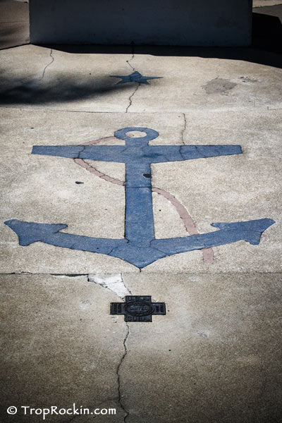 An anchor painted on the concrete inside the tribute area.