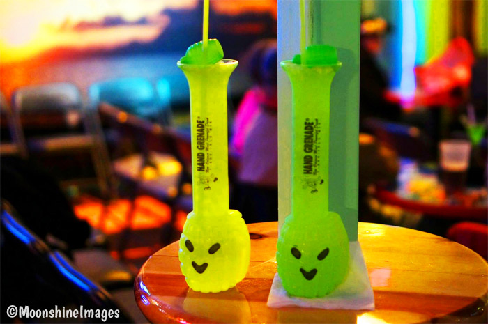 Two Hand Grenade drinks on small bar table at Tropical Isle bar.