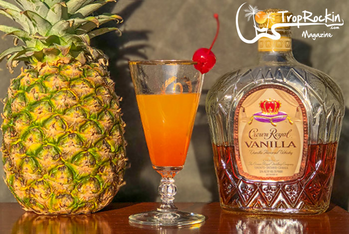 Pineapple fruit, shot drink and bottle of Crown Royal Vanilla. 