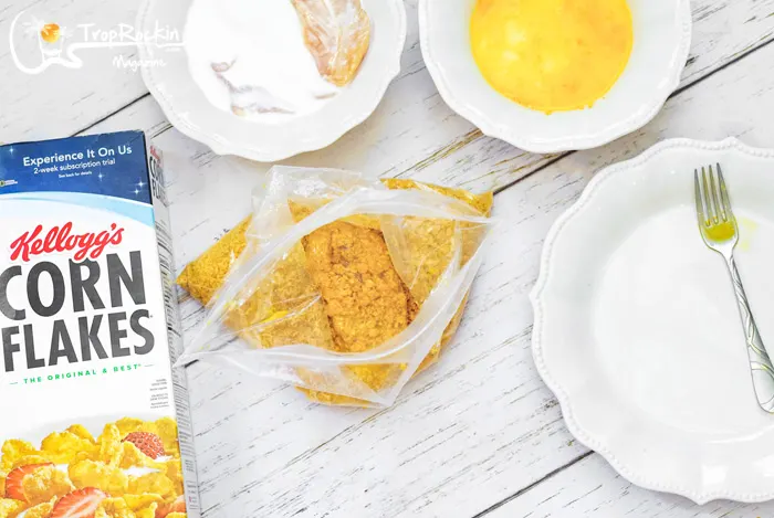Coating chicken strips in baggie full of cornflakes