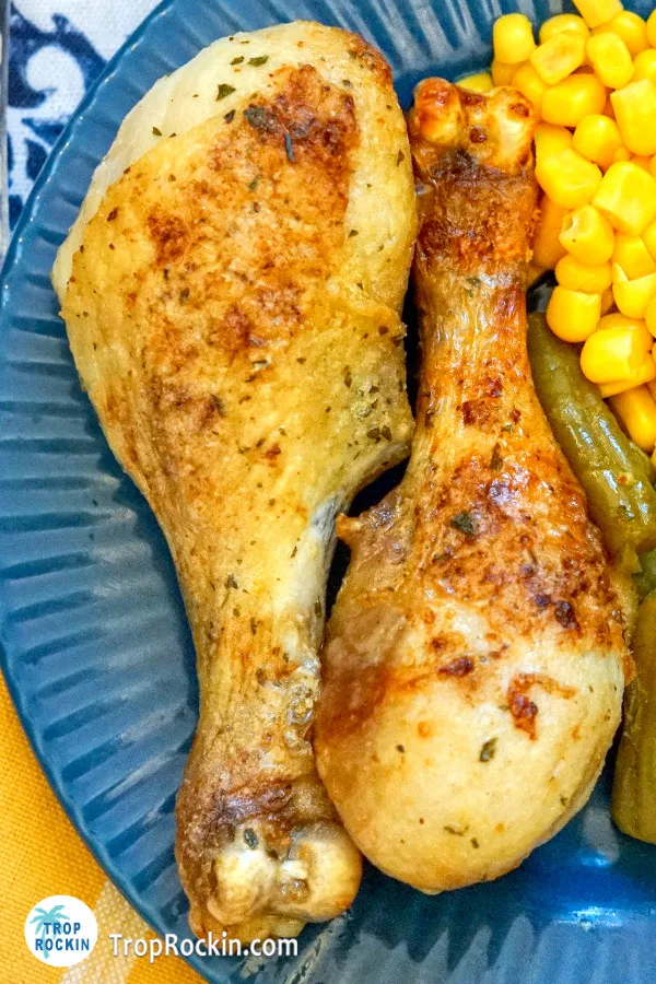 Two air fryer ranch chicken drumsticks on plate.