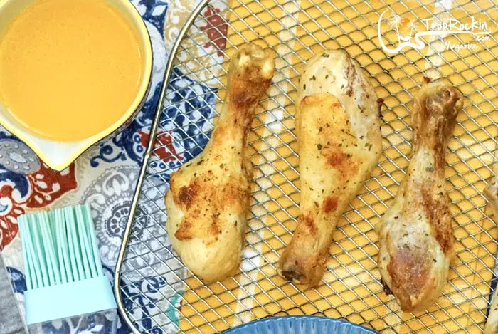 Cooked Air Fryer Chicken Legs and melted butter