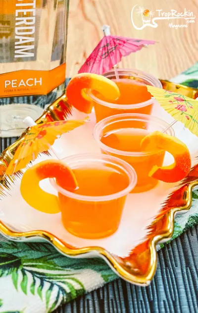 Peach vodka bottle and peach jello shots on serving platter