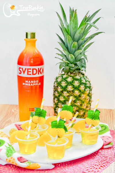Easy jello shot recipe: Svedka Mango Pineapple Vodka bottle, Pineapple fruit and finished jello shots on display