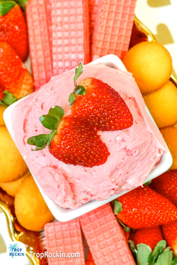 Strawberry Cream Cheese Fruit Dip topped with two fresh strawberries in a bowl.