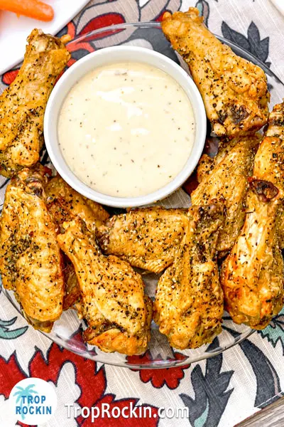 Air Fryer Lemon Pepper Wings with ranch dressing in a small bowl. 