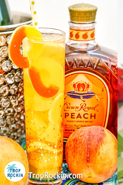 Crown Peach bottle with Crown Peach Mixed Drink with fresh peaches peach rings and mango chunks.