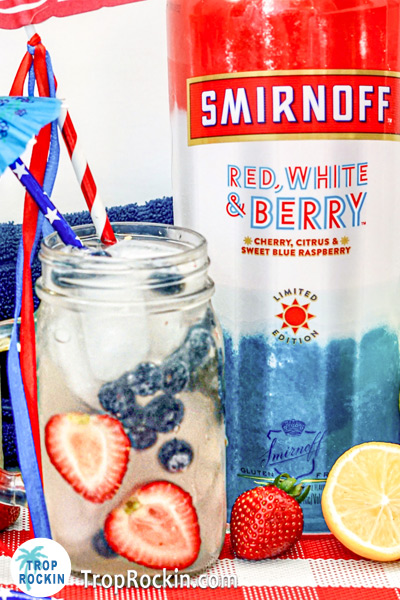 Smirnoff Red White and Berry Vodka Bottle with Vodka Lemonade Cocktail.