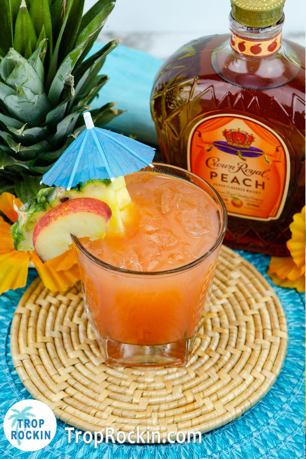 Best Summer Cocktails: The Peach Beach summer cocktail with bottle of crown royal peach in the background.