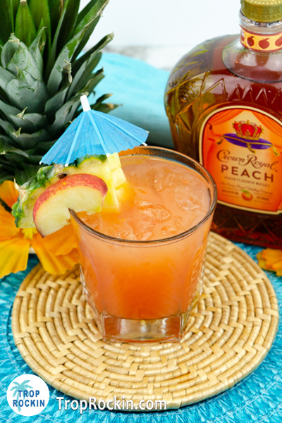 Peach Beach drink with fresh peach slice and pineapple slices. 
