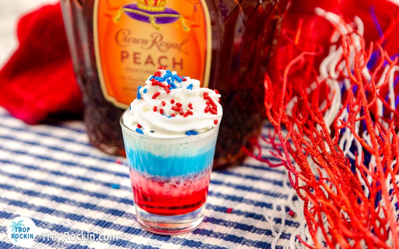 Crown Royal Peach Bottle with Layred Patriotic Shot topped with Whipped Cream and Sprinkles.