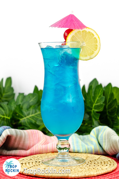 Tropical drink: The Blue Lagoon with lemon and cherries for garnish.