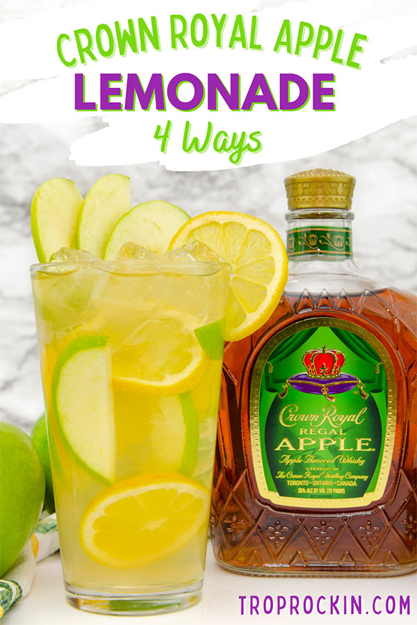 Glass of Crown Royal Apple and Lemonade with apple slices and lemon slices along with a Crown Royal Apple bottle and fresh green apples.