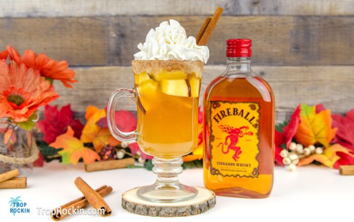 Fireball Apple Cider drink with Fireball Whisky bottle in background.