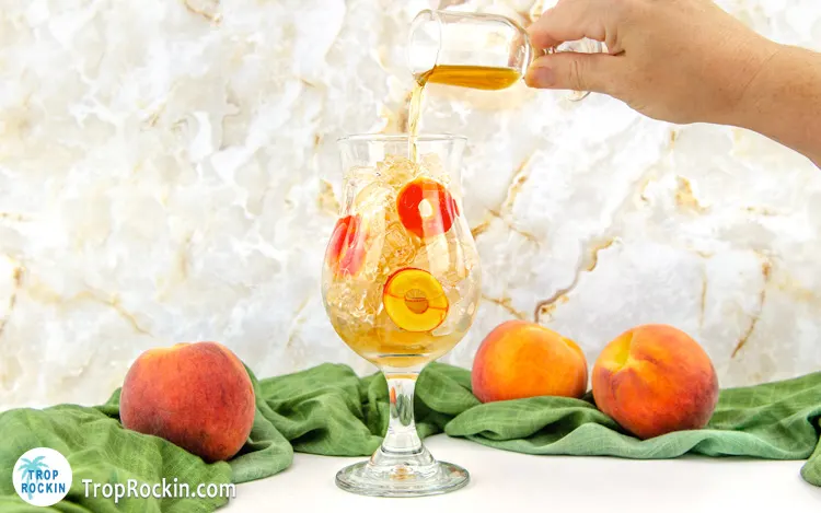 Pouring a shot of Crown Royal Peach into drink glass.