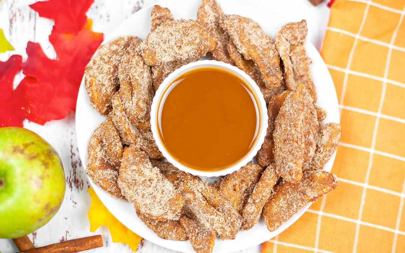 Air Fryer Apple Fries on a plate with warm caramel sauce in a small bowl.