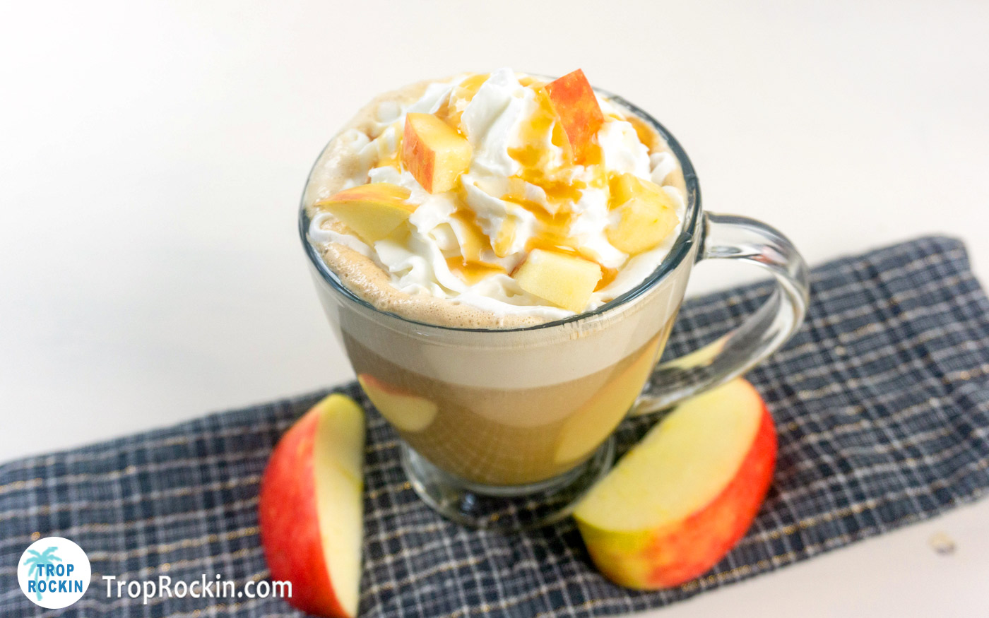 Apple Cider Latte with whipped cream and caramel sauce. Topped with small chunks of fresh apple. 