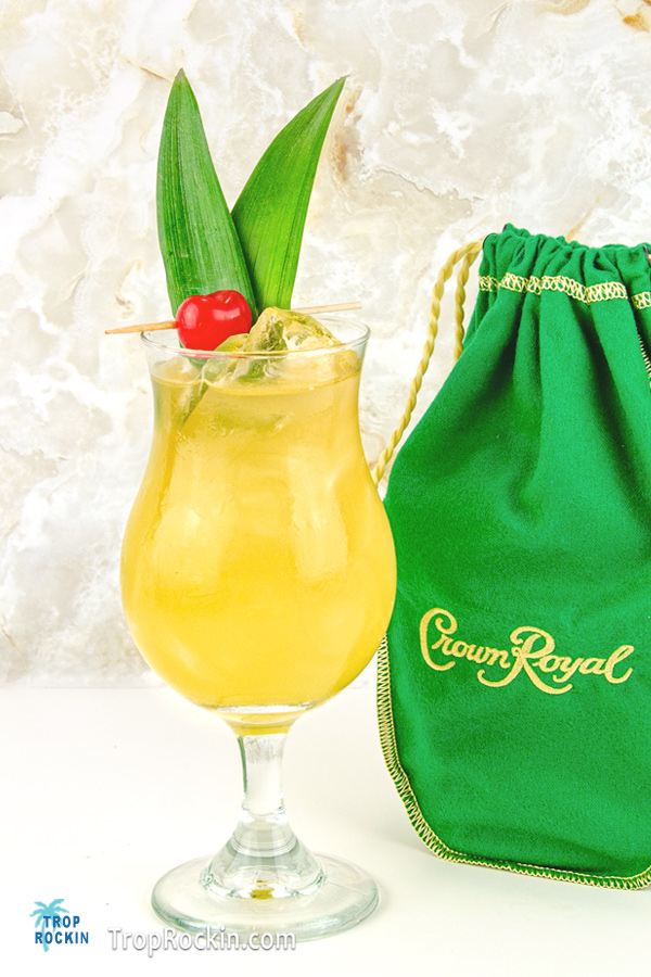 Crown Apple and Pineapple Juice drink with a bottle of Crown Royal Apple whisky in the background.