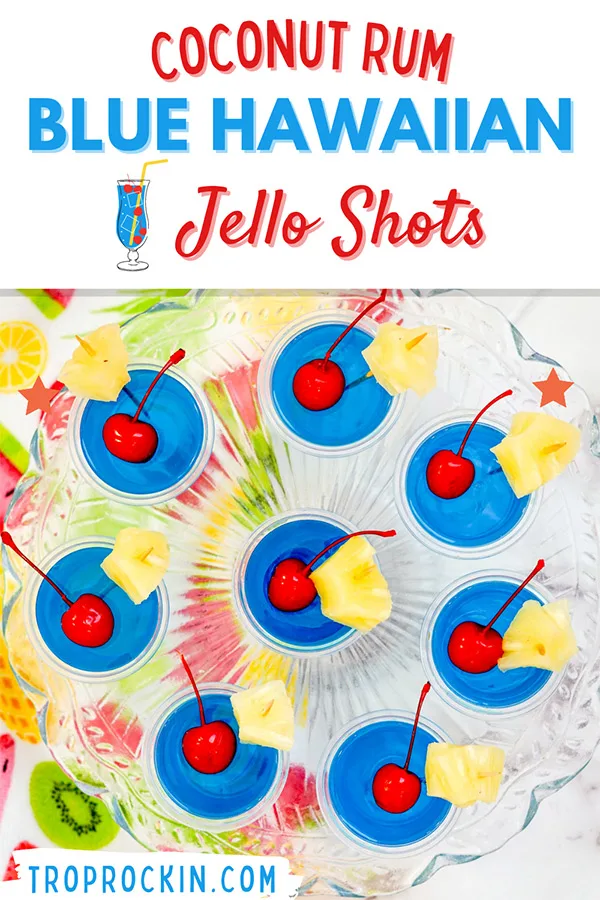 Blue Hawaiian Jello Shots with maraschino cherries and pineapple chunks for garnish on a serving platter with title for pin to save to pinterest.