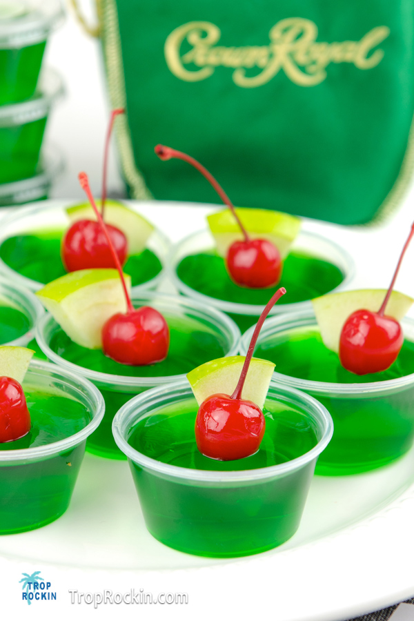 Crown Apple Jello Shots with bottle of Crown Royal Apple whisky in the background.