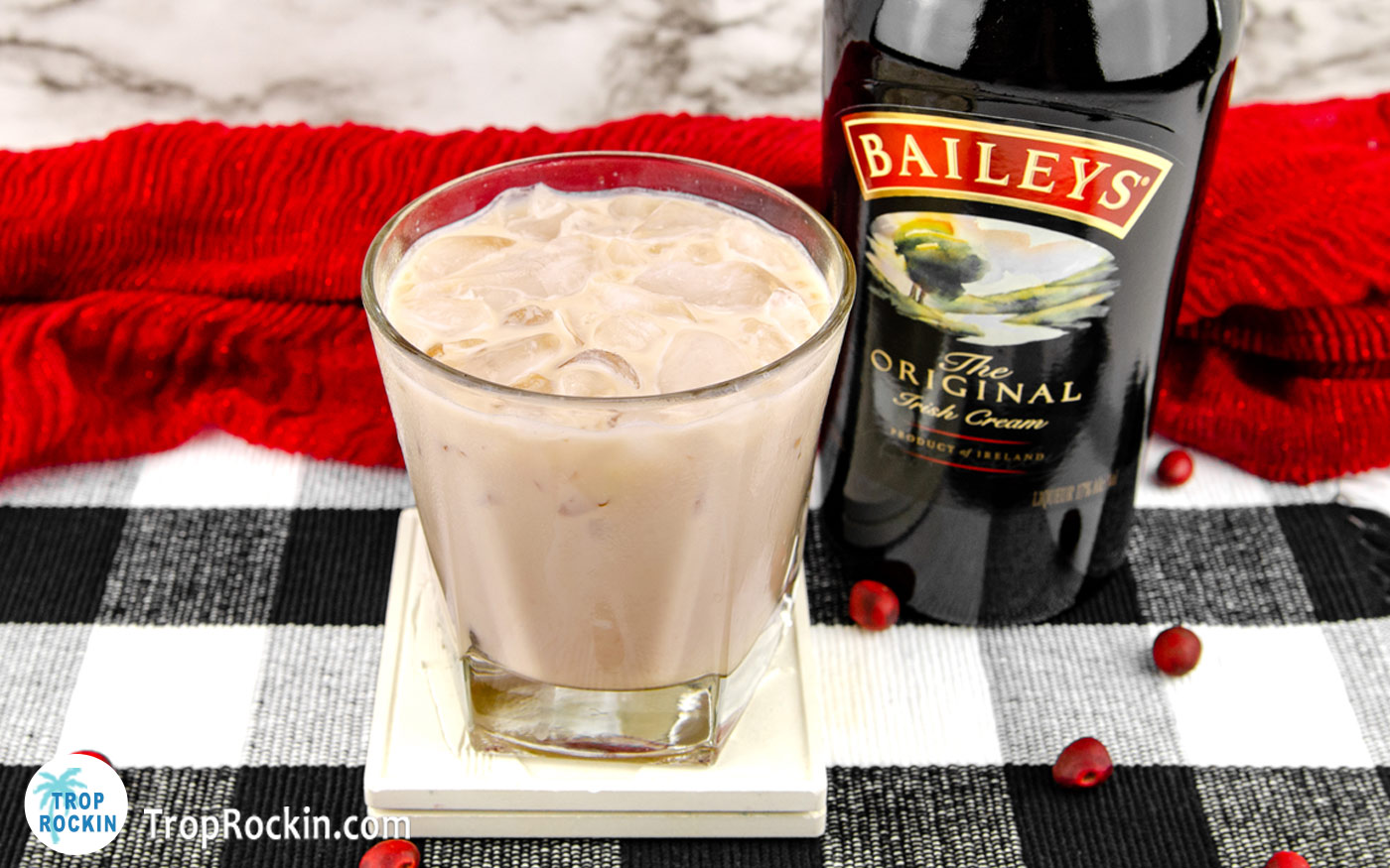 Bailey's White Russian drink with a bottle of Bailey's Irish Cream in the background.