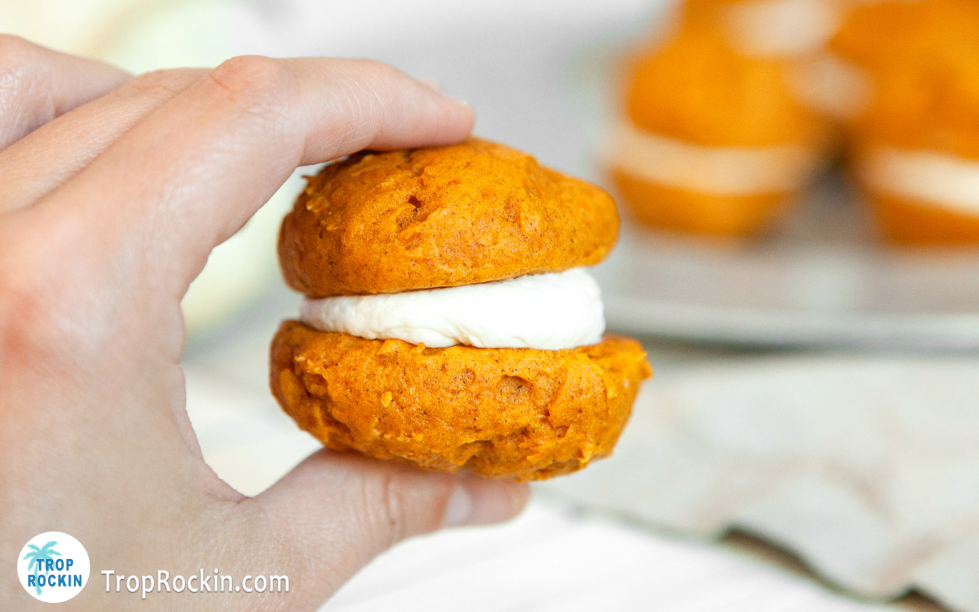 Holding one cake mix pumpkin whoopie pies.