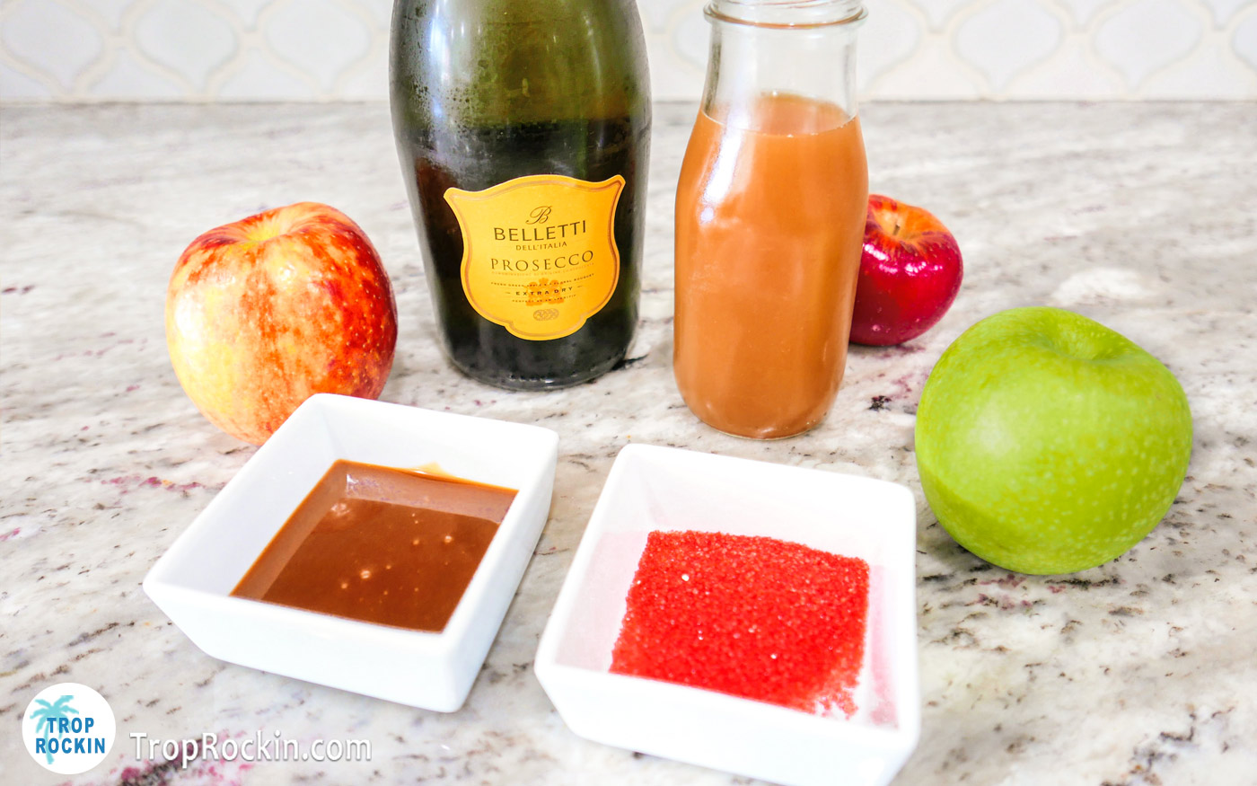 Ingredients for a Caramel Apple Mimosa displayed on a counter top.