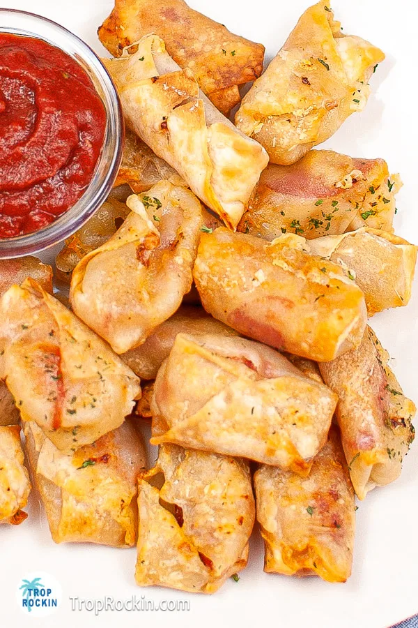 Top view of a plate of air fryer pepperoni pizza rolls.