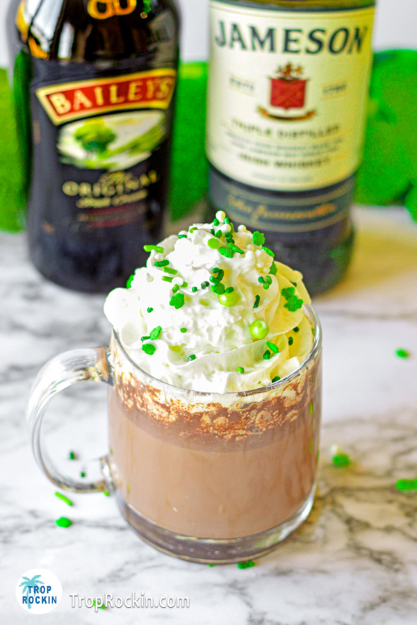 Irish Hot Chocolate drink with a bottle of Bailey's Irish Cream and a bottle of Jameson Irish whiskey in the background.