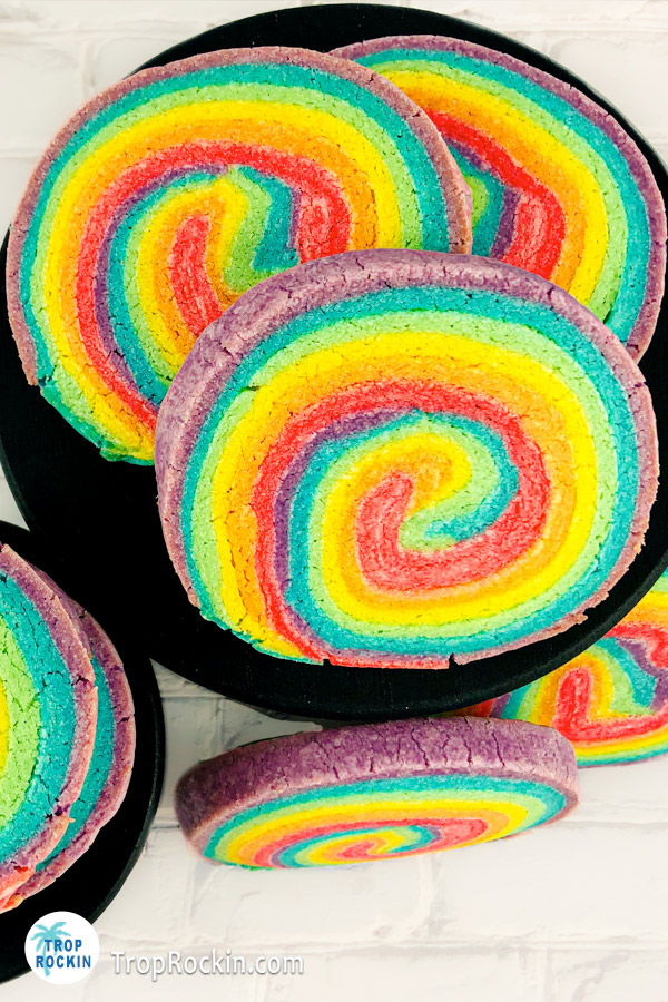Rainbow pinwheel sugar cookies on serving plate.