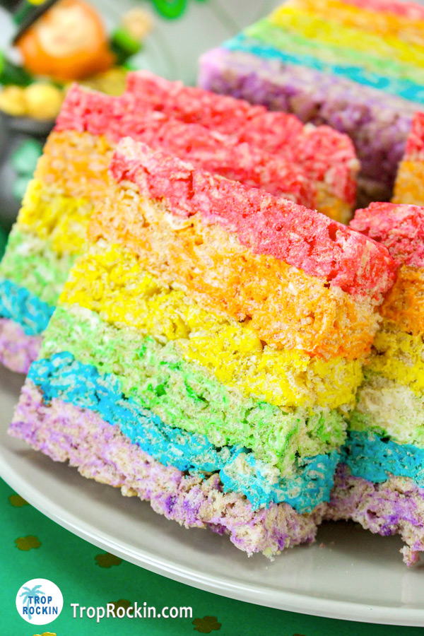 Up close view of raninbow rice krispie treats on a plate.
