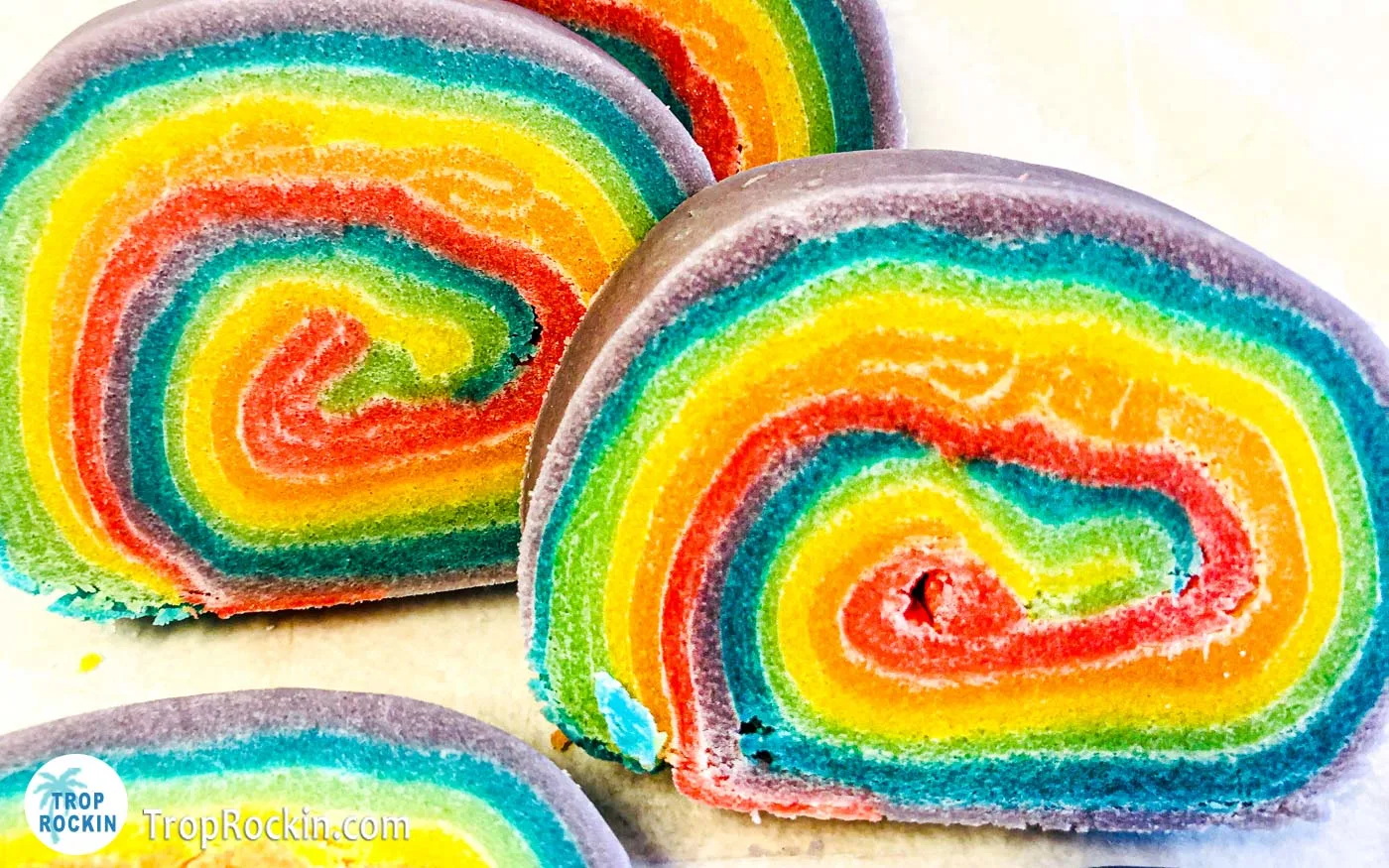 Rainbow cookie dough log sliced into cookies.
