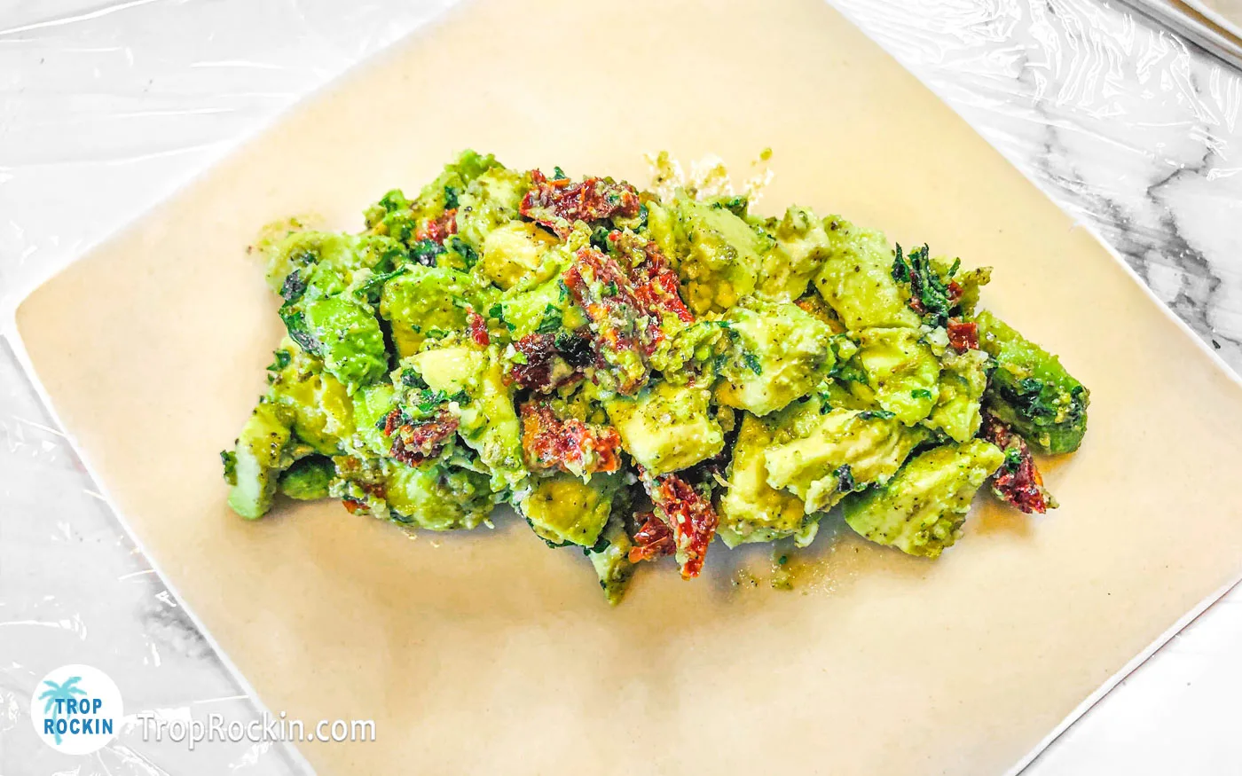 Avocado mixture on top of an egg roll wrapper in the middle.
