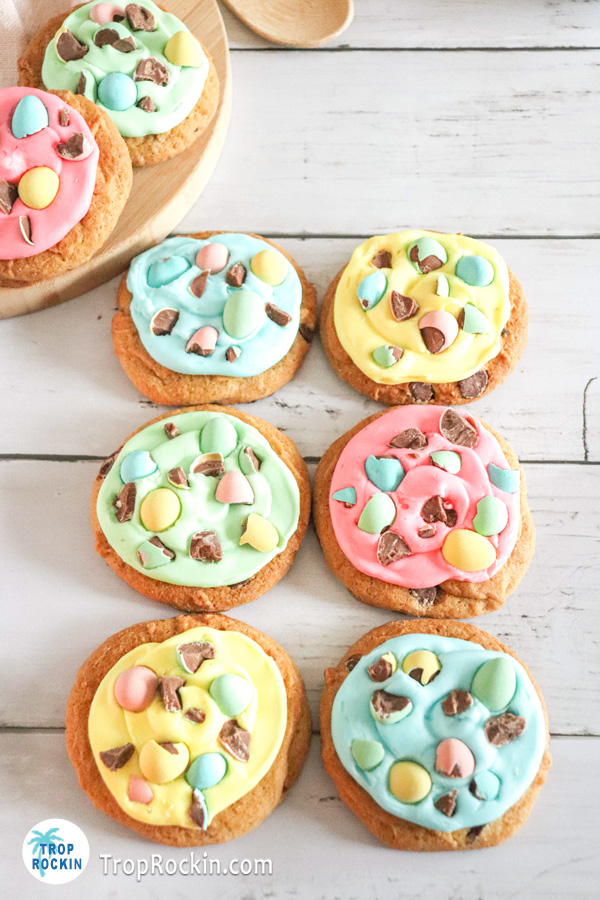 Six easter cookies displayed on a white wood background.