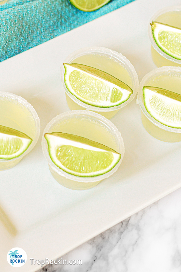 Top view of margarita tequila jello shots with a lime wedge on top.