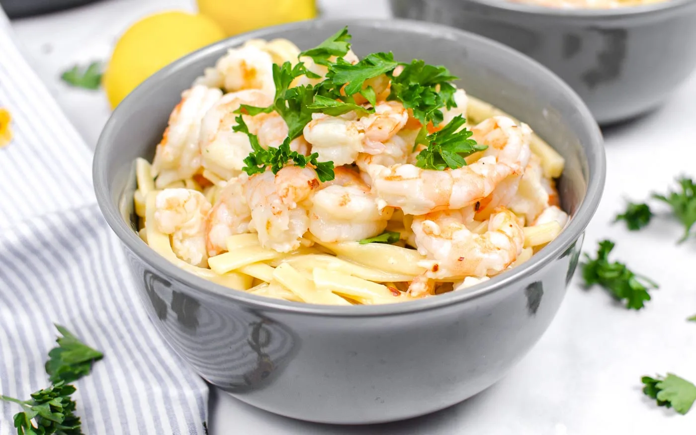 Instant Pot Shrimp Scampi topped with parsley in a gray bowl