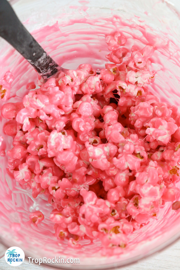 Melted butter and marshmallows mixed with red food coloring and popcorn.