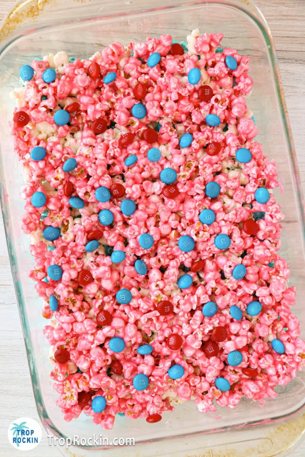 Patriotic Popcorn Cake topped with red and blue M&Ms in the baking pan.