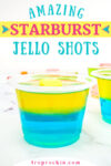Starburst Jello Shots with focus on one jello shot with blue raspberry bottom layer and lemon jello top layer with a yellow starburst candy on top. Text overlay on the top of photo that says "Amazing Starburst Jello Shots".