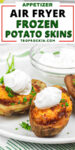 Test overlay on top with the words "appetizer: air fryer frozen potato skins" with photo of 2 potato skins on a plate topped with sour cream and a bowl of sour cream in the background.