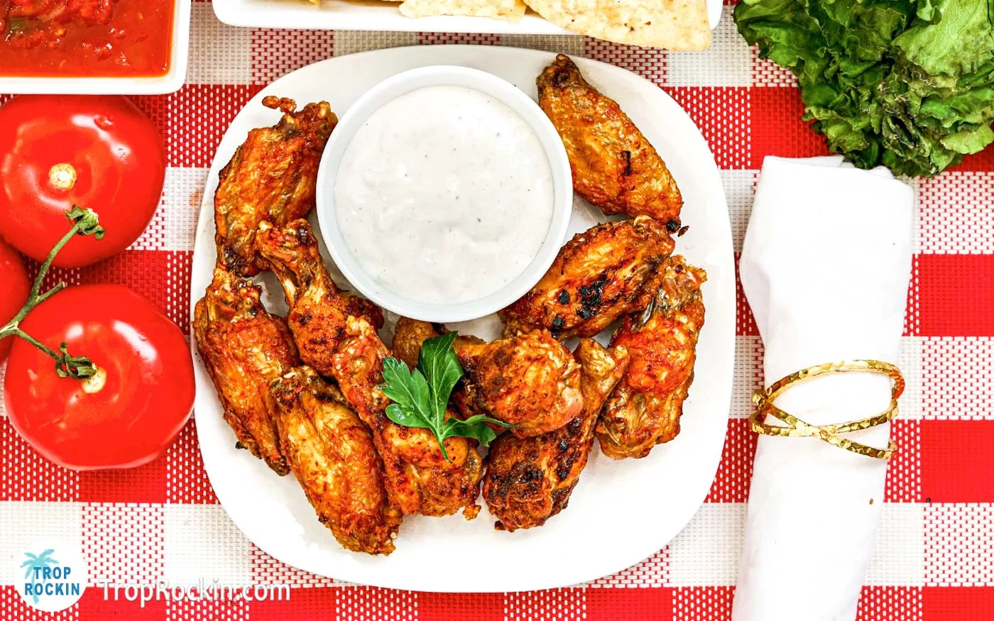 Plate of air fryer mexican wings with a small bowl of ranch dressing.