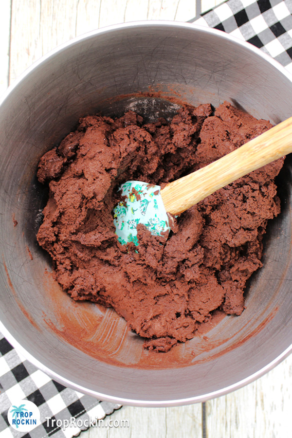 Halloween Chocolate Cookie dough in a large mixing bowl with spatchula.