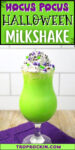 Bright green milkshake with whipped cream and sprinkles on top with text overlay that says Hocus Pocus Halloween Milkshake for sharing to social media.
