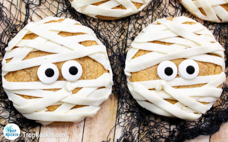 Two maple cinnamon mummy cookies with candy eyeballs.