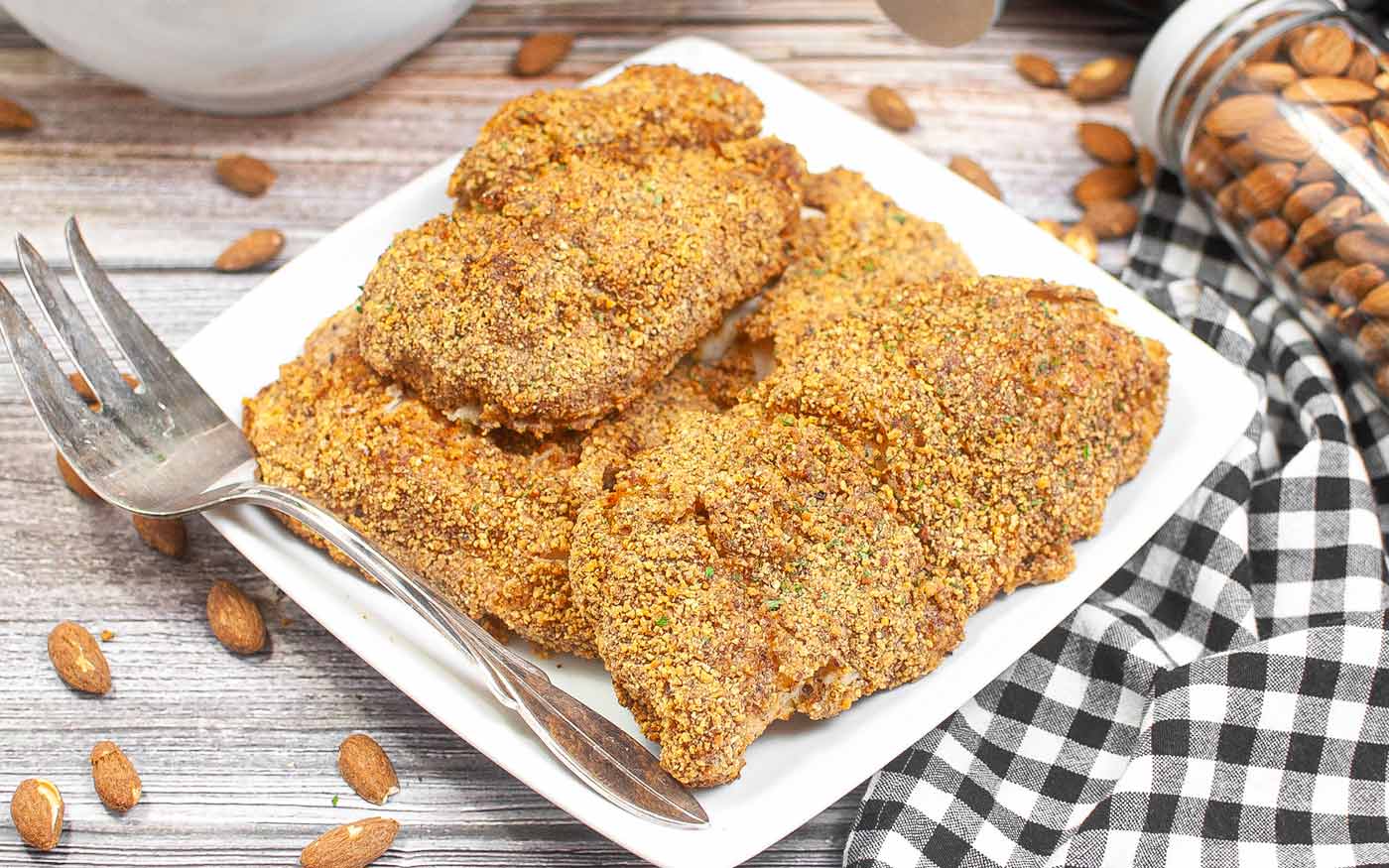 Plate with four air fryer almond crusted chicken.