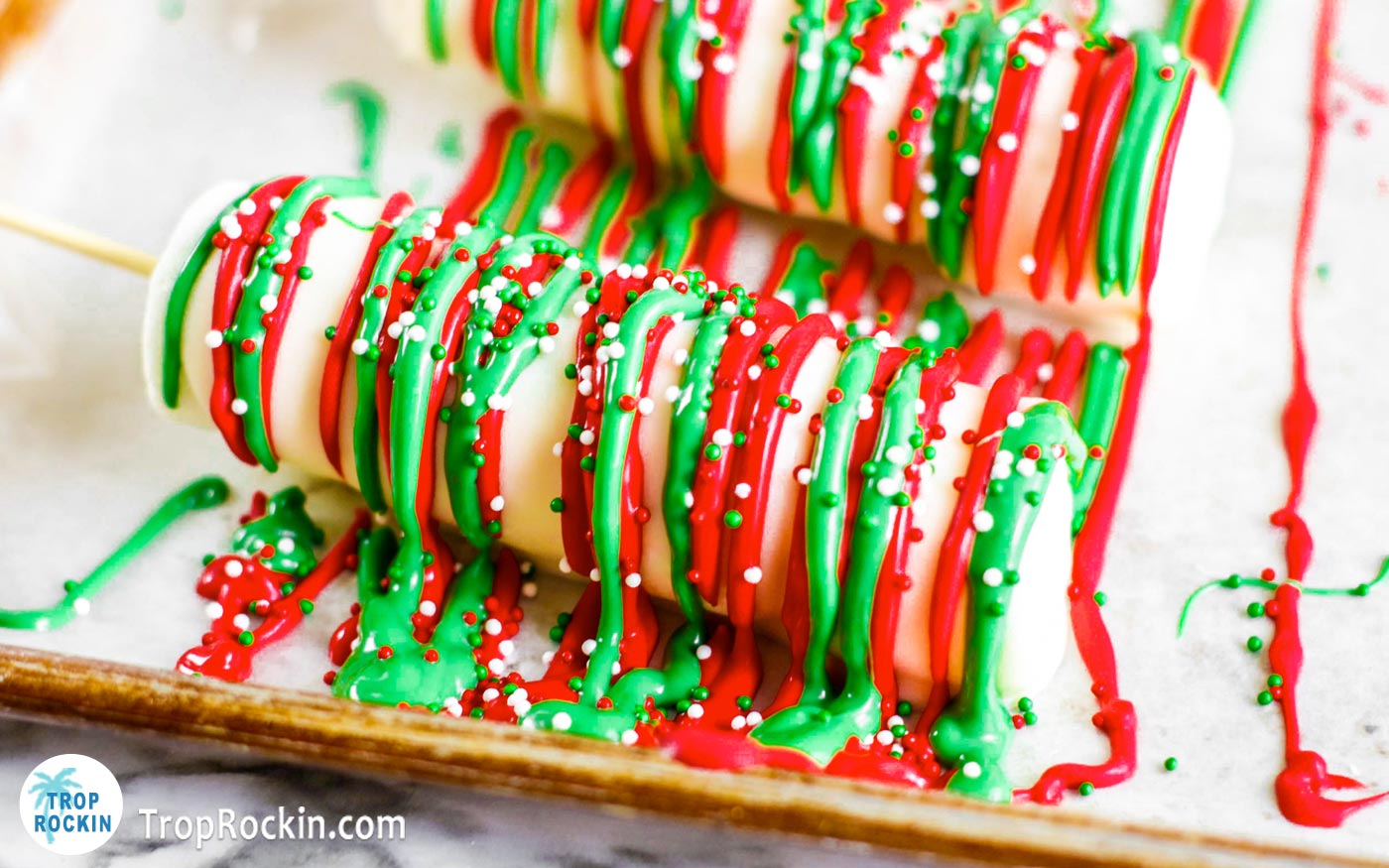 Marshmallow pops drizzled with both melted red and green candy melts and red, white and green Christmas sprinkles on top.