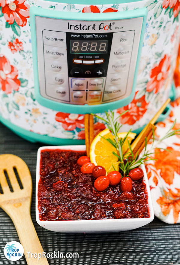 Bowl of fresh cranberry sauce with an instant pot in the background.