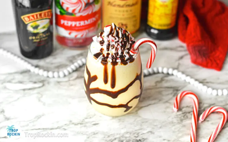 Peppermint Mudslide drink with liquor bottles in the background.