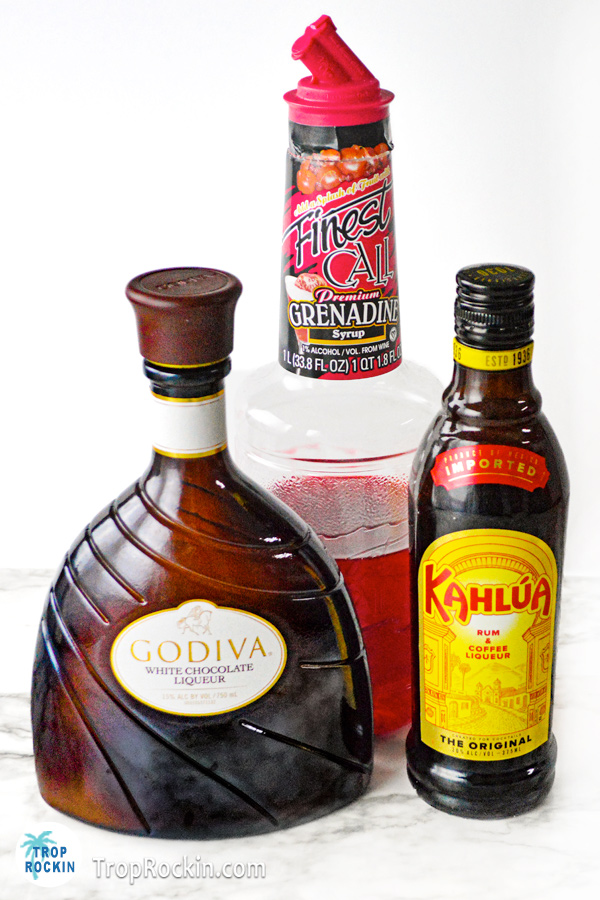 Bottle of Kahlua, Bottle of Godiva White Chocolate Liqueur and bottle of Grenadine.
